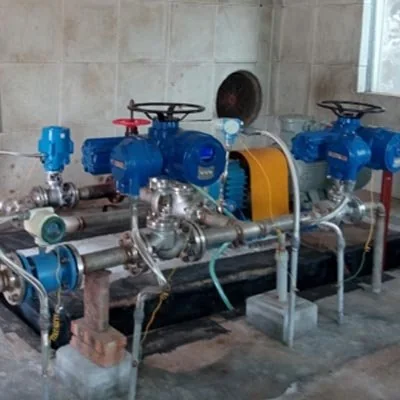 Blue pump with a yellow coupling guard and connected piping